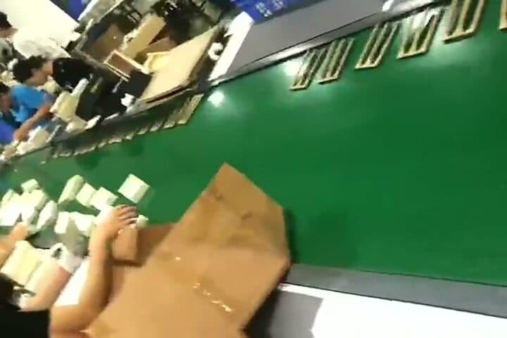 Kraft folding cartons coming off the production line and being packed into a shipping case