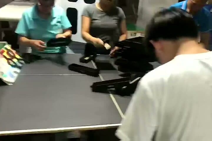 Finished rigid boxes being assembled and packed by hand at a bench